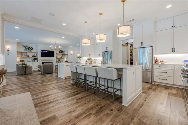 6301 New Bethany Rd, Buford, GA 30518 - kitchen featuring built in refrigerator, stainless steel refrigerator, a barn door, light wood-type flooring, and light countertops