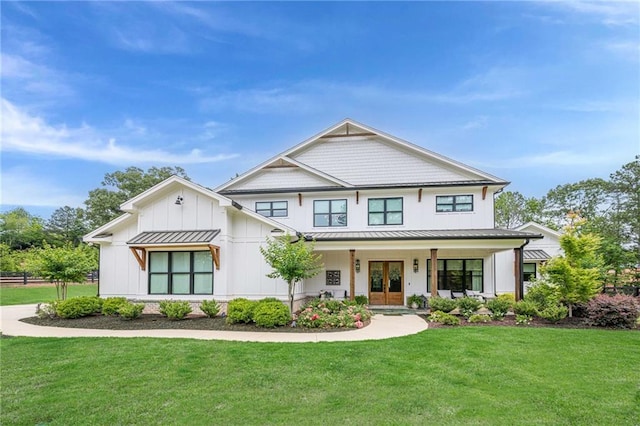6301 New Bethany Rd, Buford, GA 30518 - modern farmhouse style home featuring covered porch, a front yard, a standing seam roof, board and batten siding, and french doors