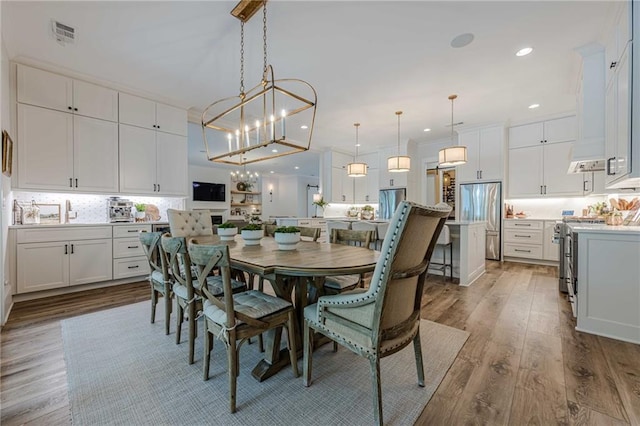 6301 New Bethany Rd, Buford, GA 30518 - dining space featuring a chandelier, wood finished floors, and recessed lighting