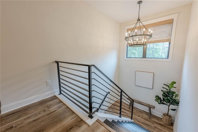 6301 New Bethany Rd, Buford, GA 30518 - staircase featuring a chandelier, wood finished floors, and baseboards
