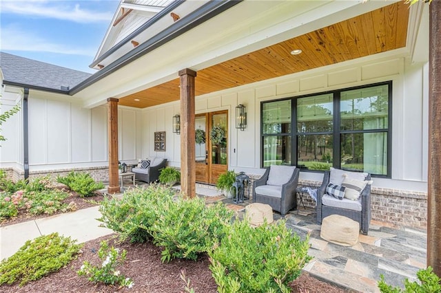 6301 New Bethany Rd, Buford, GA 30518 - doorway to property featuring board and batten siding, french doors, a porch, and outdoor lounge area