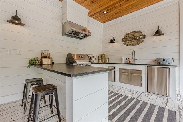 6301 New Bethany Rd, Buford, GA 30518 - kitchen featuring fridge, dark countertops, a sink, wood ceiling, and wood walls