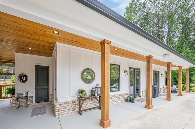 6301 New Bethany Rd, Buford, GA 30518 - entrance to property featuring french doors, board and batten siding, and a porch
