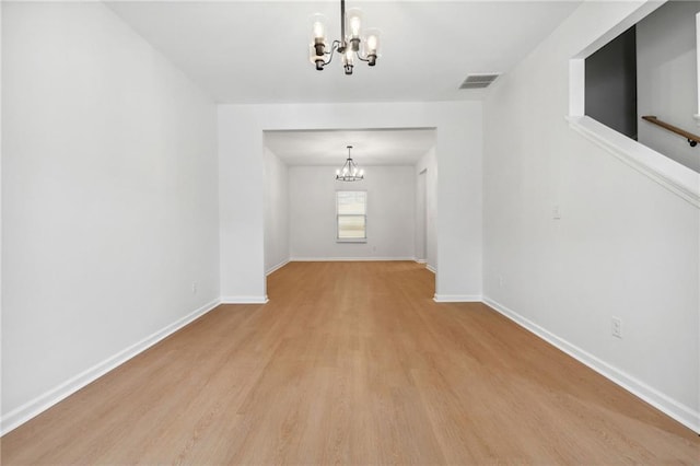 interior space with light wood-type flooring and a notable chandelier