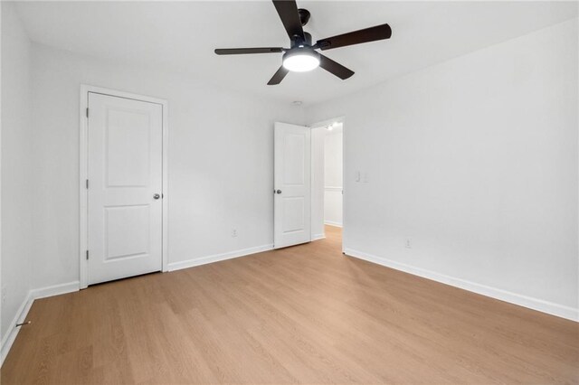 empty room featuring ceiling fan and light hardwood / wood-style floors