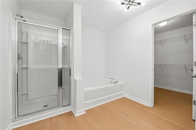 bathroom featuring wood-type flooring and independent shower and bath