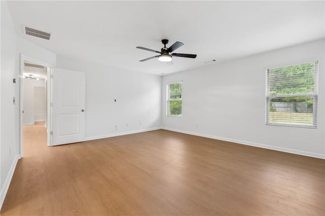 empty room with ceiling fan and hardwood / wood-style floors