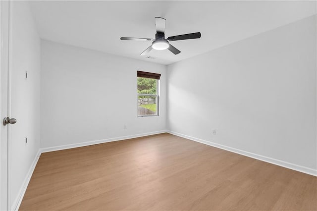 spare room with ceiling fan and light wood-type flooring