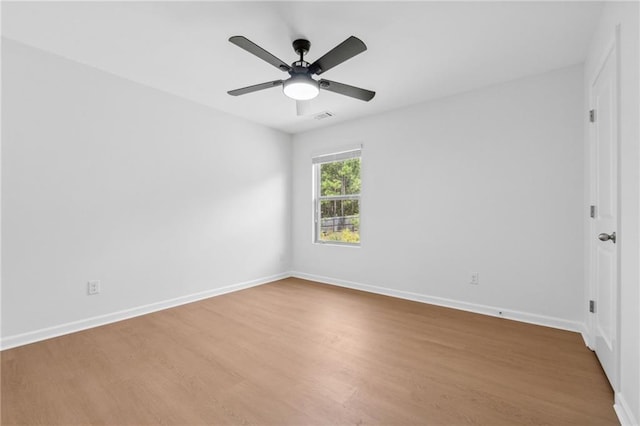 unfurnished room with ceiling fan and hardwood / wood-style flooring