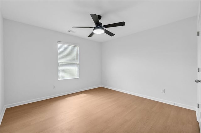 spare room featuring ceiling fan and light wood-type flooring