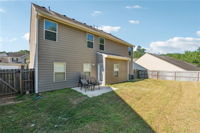 rear view of property with cooling unit, a patio area, and a lawn