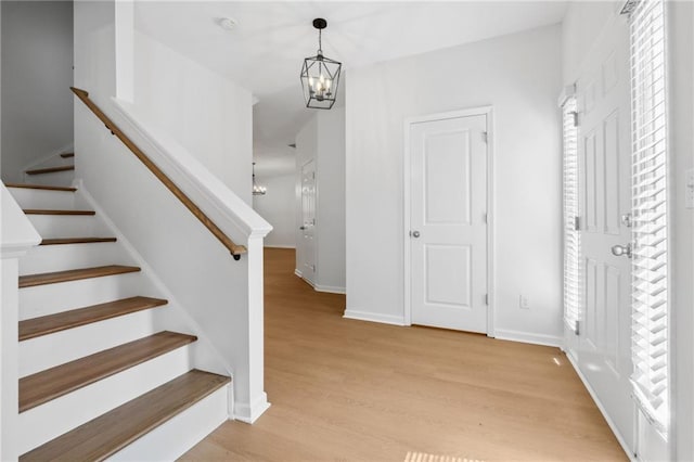 stairway featuring a chandelier and hardwood / wood-style flooring