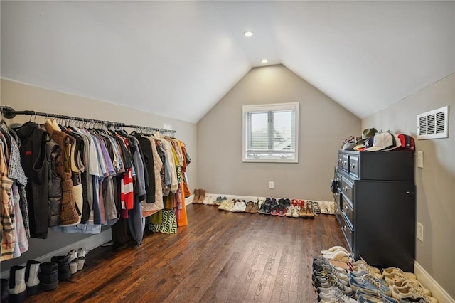 walk in closet featuring dark hardwood / wood-style flooring and vaulted ceiling