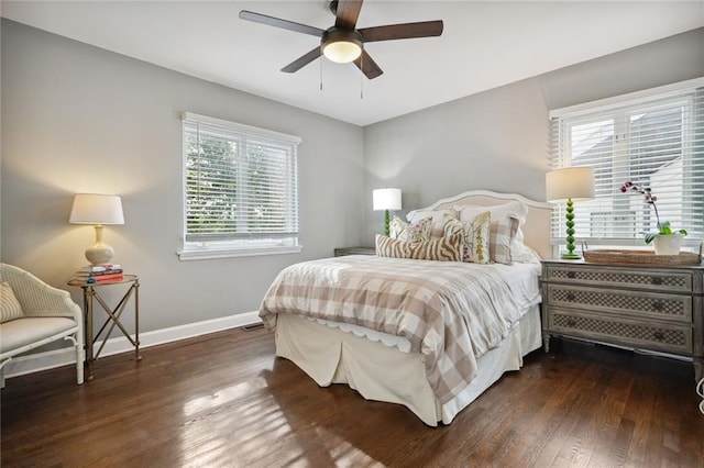 bedroom with multiple windows, ceiling fan, and dark hardwood / wood-style floors