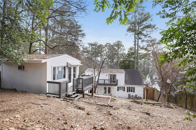 rear view of property with a deck, a patio, and french doors