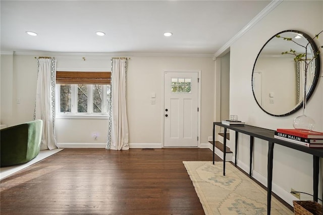 foyer entrance featuring ornamental molding, dark hardwood / wood-style flooring, and a healthy amount of sunlight