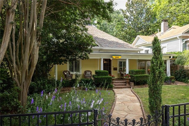 view of front of home with a front yard and a porch