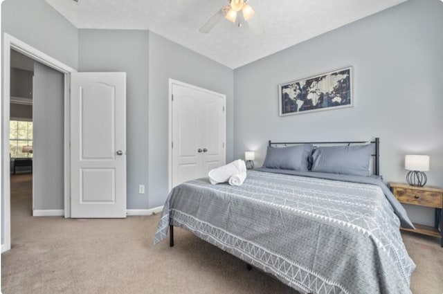 carpeted bedroom featuring ceiling fan and a closet