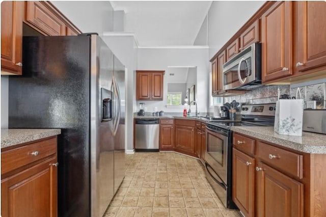 kitchen featuring stainless steel appliances, tasteful backsplash, and lofted ceiling