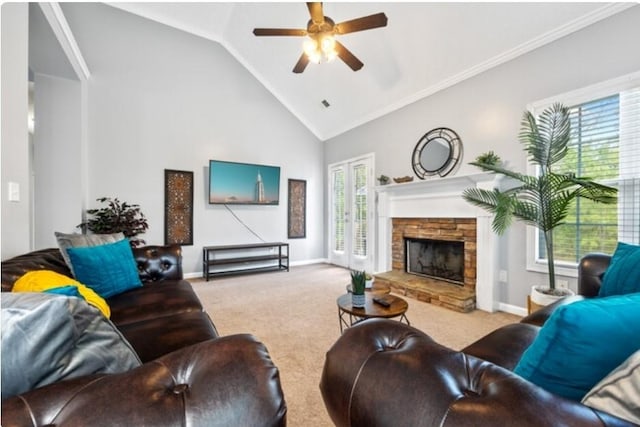 living room featuring a wealth of natural light, ceiling fan, carpet floors, and a fireplace