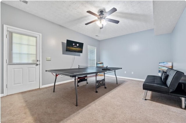 office area with a textured ceiling, carpet, and ceiling fan