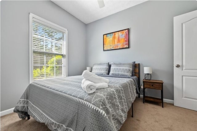 bedroom with light carpet and ceiling fan