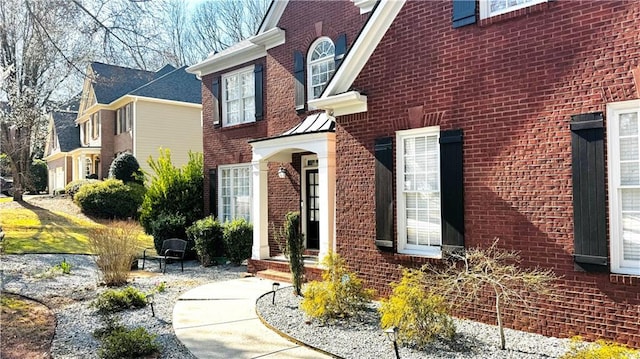 doorway to property featuring brick siding