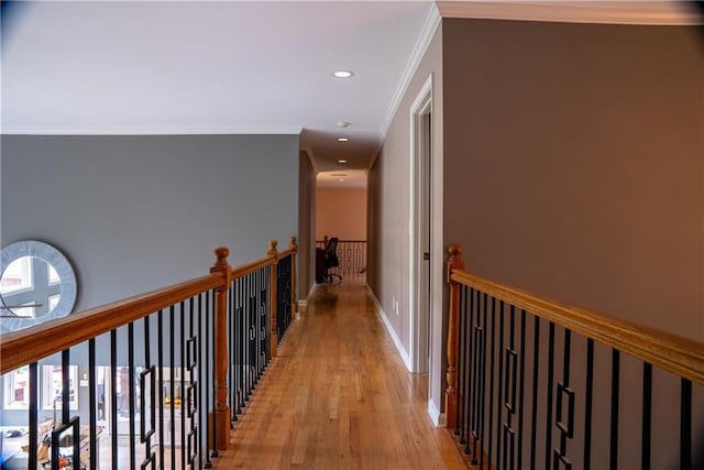 corridor with recessed lighting, light wood-style flooring, baseboards, and crown molding