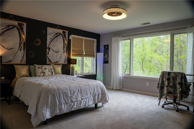 carpeted bedroom with visible vents and baseboards