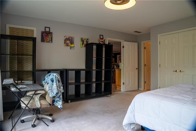 bedroom with visible vents, a closet, and carpet