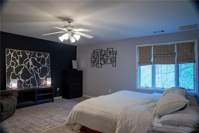 bedroom with a ceiling fan, visible vents, and carpet floors