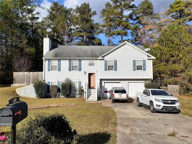 split foyer home with a front lawn and a garage