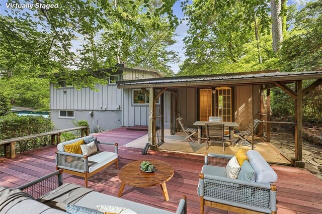 wooden terrace with outdoor lounge area and outdoor dining space
