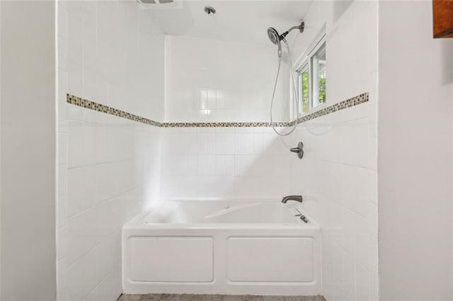 full bathroom featuring bathing tub / shower combination and tile walls