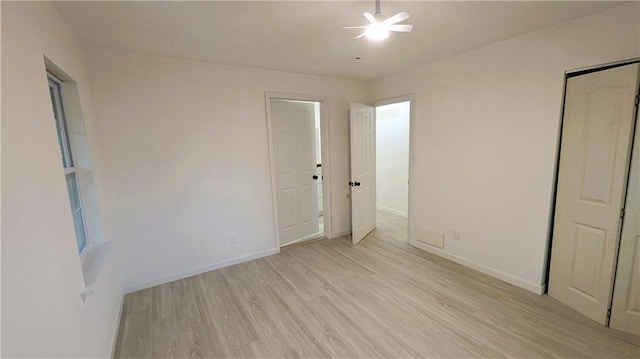 unfurnished bedroom with ceiling fan and light wood-type flooring