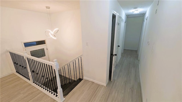 corridor with hardwood / wood-style flooring