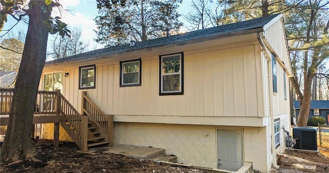 rear view of property featuring central AC