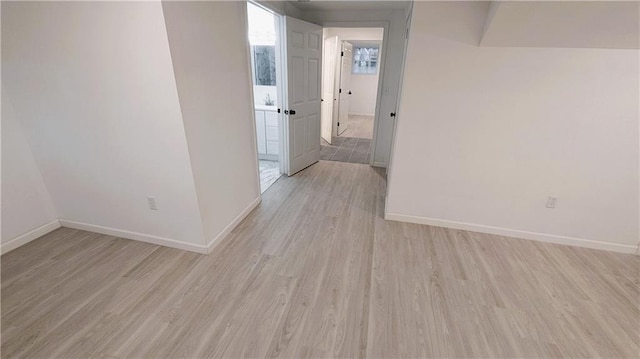 corridor with light hardwood / wood-style floors