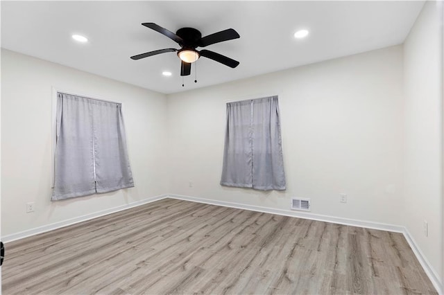 empty room with light hardwood / wood-style floors and ceiling fan