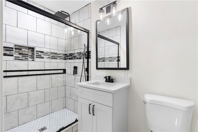 bathroom with toilet, an enclosed shower, and vanity