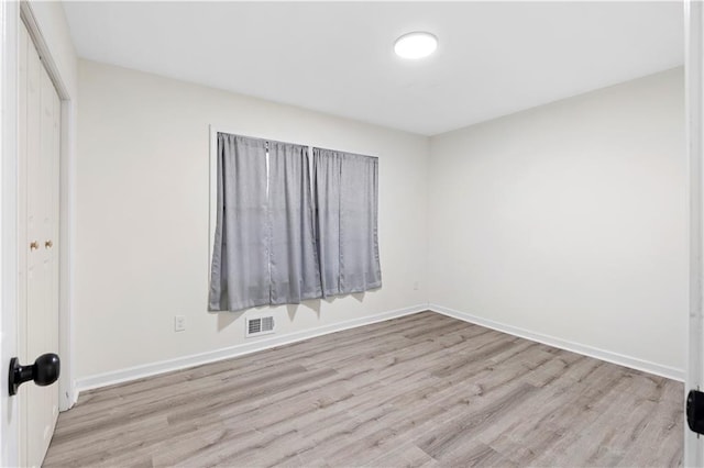 unfurnished room with light hardwood / wood-style floors