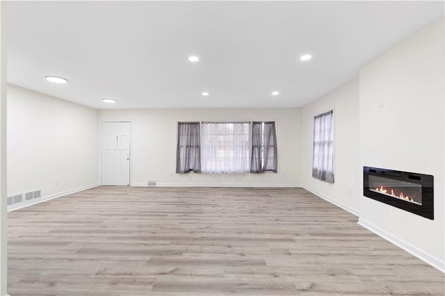 unfurnished living room with light wood-type flooring