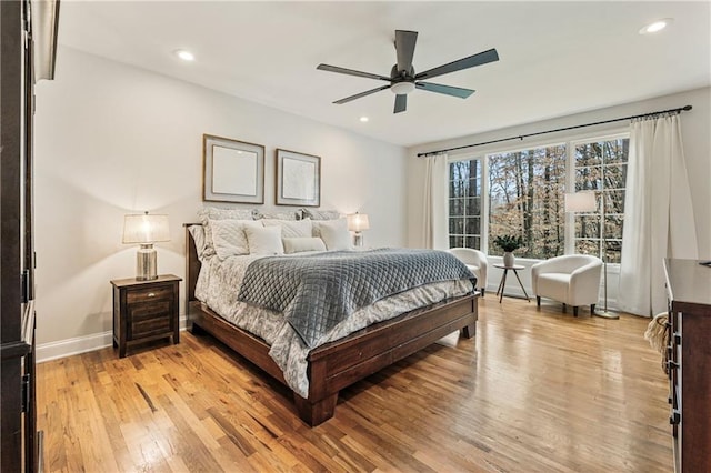 bedroom featuring ceiling fan, light wood finished floors, recessed lighting, and baseboards