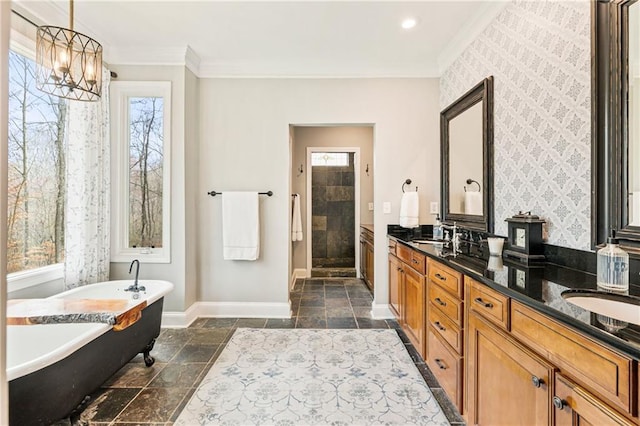 full bathroom with stone tile floors, baseboards, a soaking tub, a stall shower, and crown molding