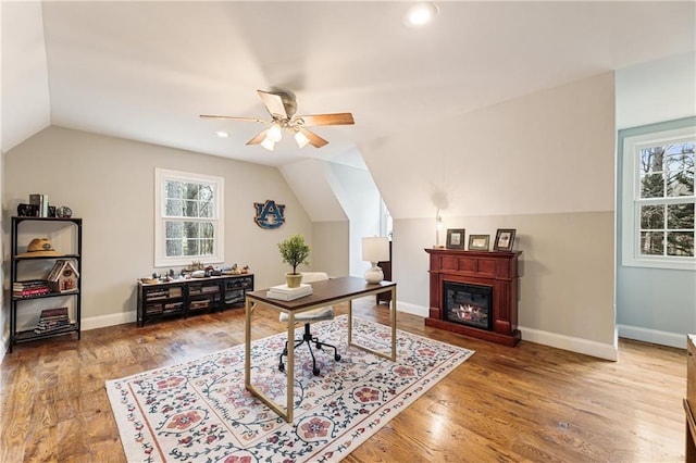 office featuring wood finished floors, a wealth of natural light, and baseboards