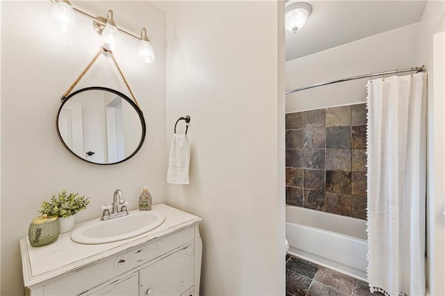 full bathroom featuring stone finish flooring, shower / bath combination with curtain, and vanity