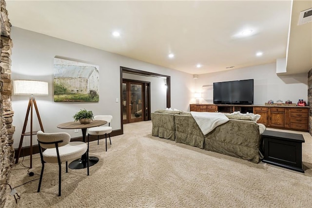 living area featuring recessed lighting, light colored carpet, visible vents, and baseboards