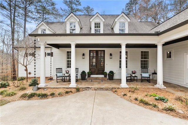 view of front of house featuring roof with shingles, a porch, and french doors