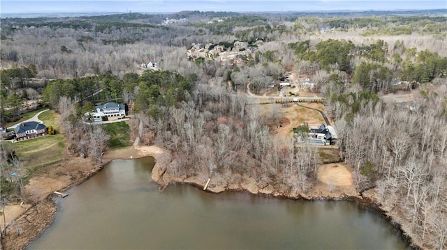 birds eye view of property featuring a water view and a forest view