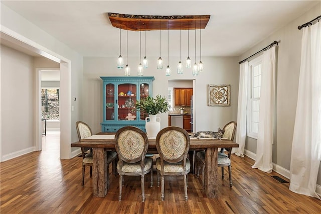 dining area featuring baseboards and wood finished floors